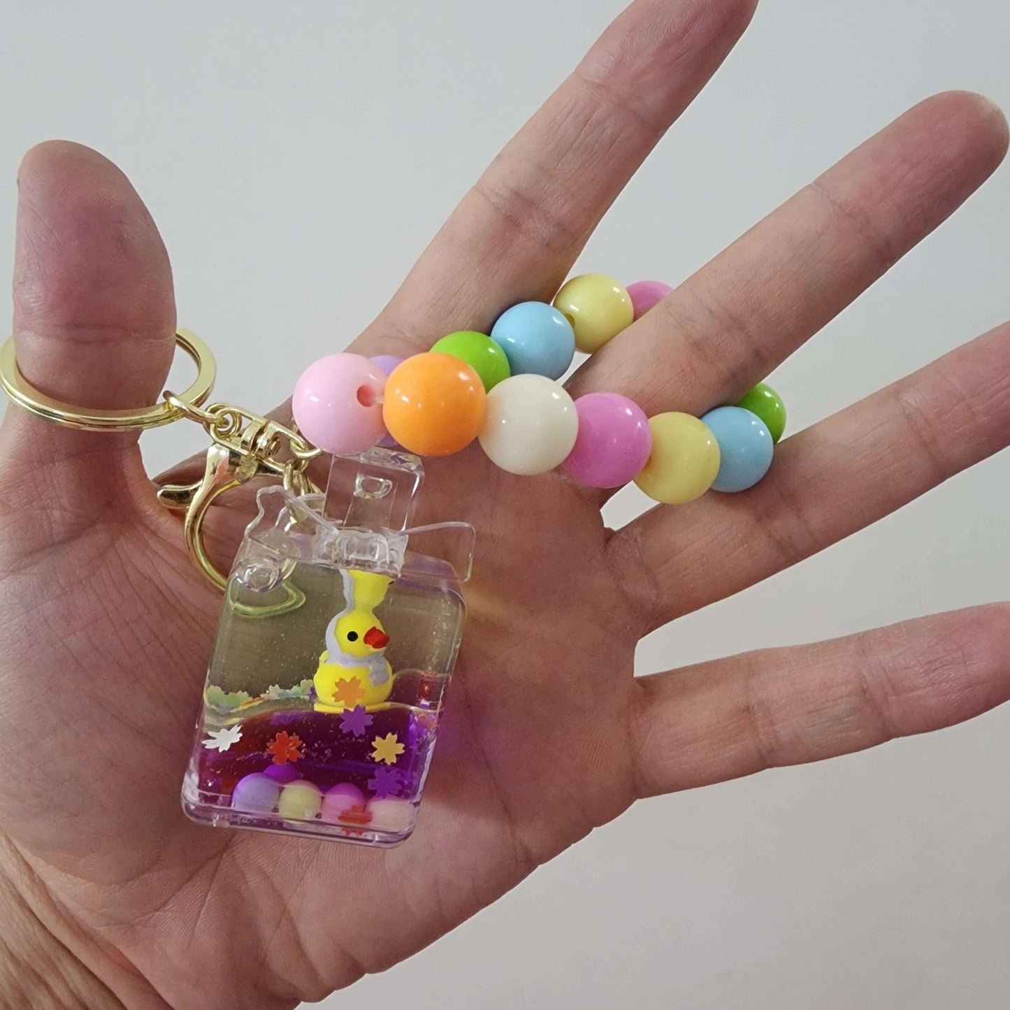 Colorful key ring with a cute bunny charm and beads, perfect for keeping your keys stylishly organized.