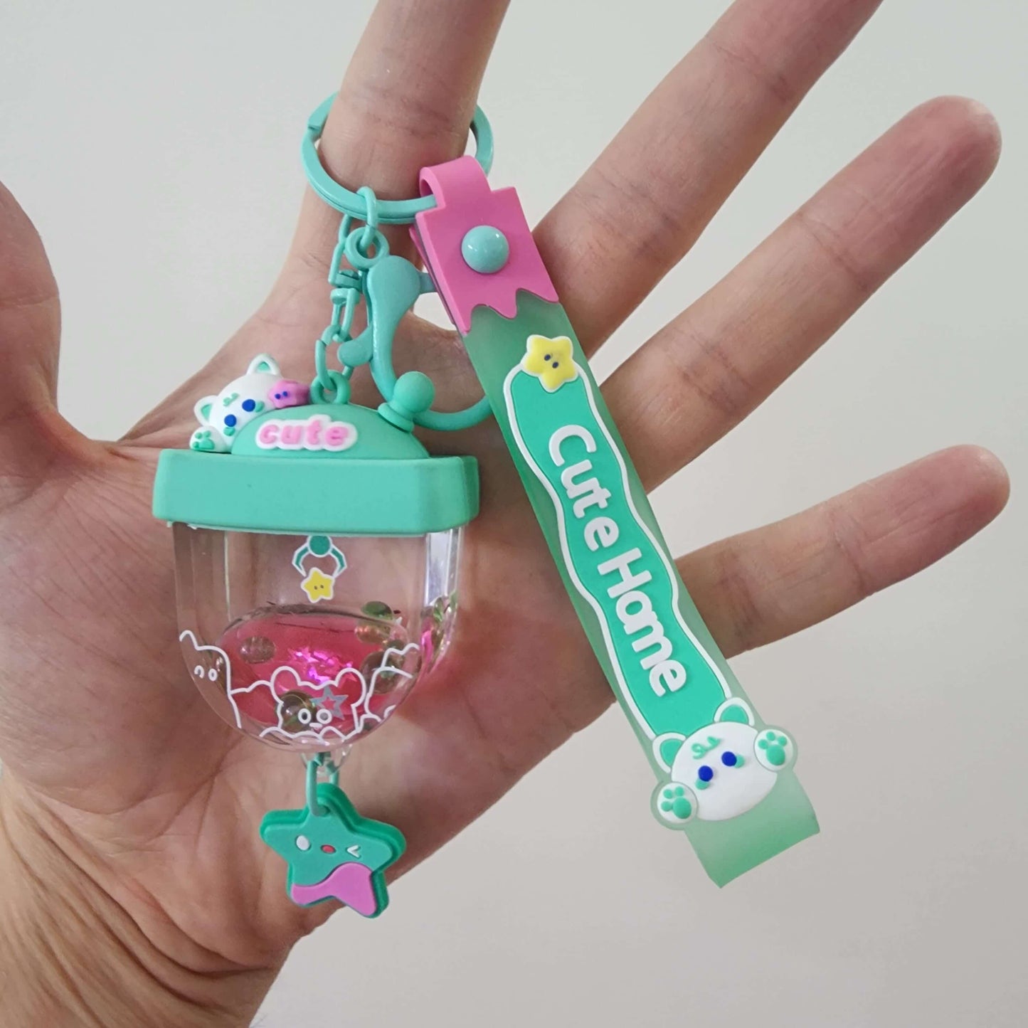 Cute key ring featuring a colorful design with a charm and unique shapes, perfect for personalization and everyday use.