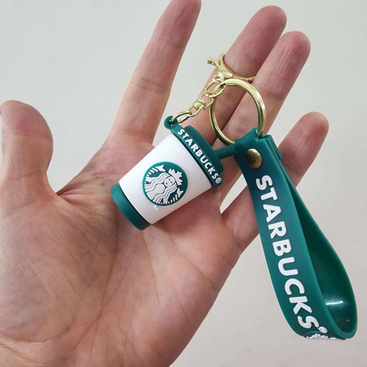 Starbucks key ring featuring a mini coffee cup and green strap, perfect for organizing keys.