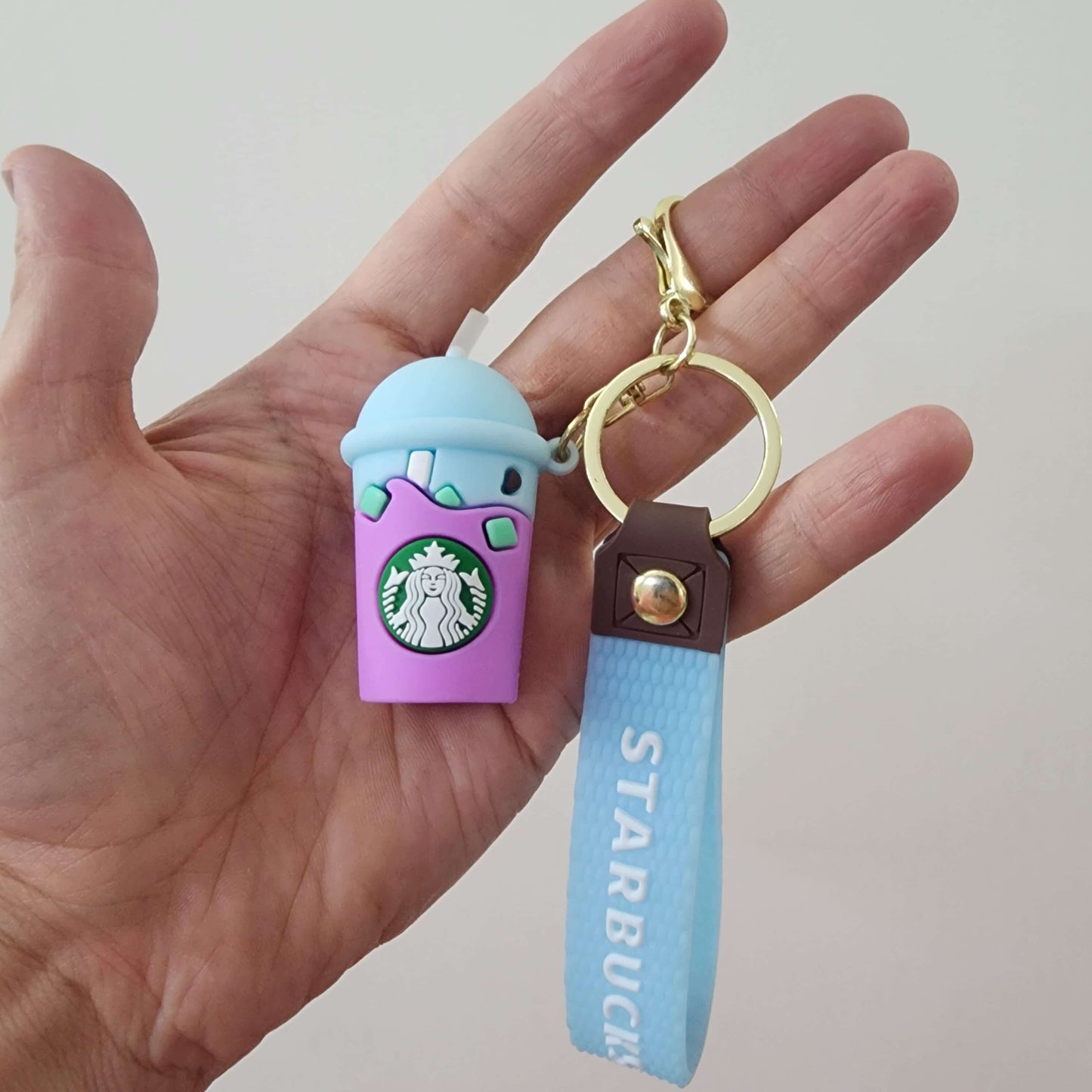 Colorful key ring with Starbucks cup charm and blue wrist strap, perfect for organizing keys.