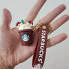 Cute Starbucks key ring featuring a mini frappuccino charm with a brown strap, perfect for coffee lovers.